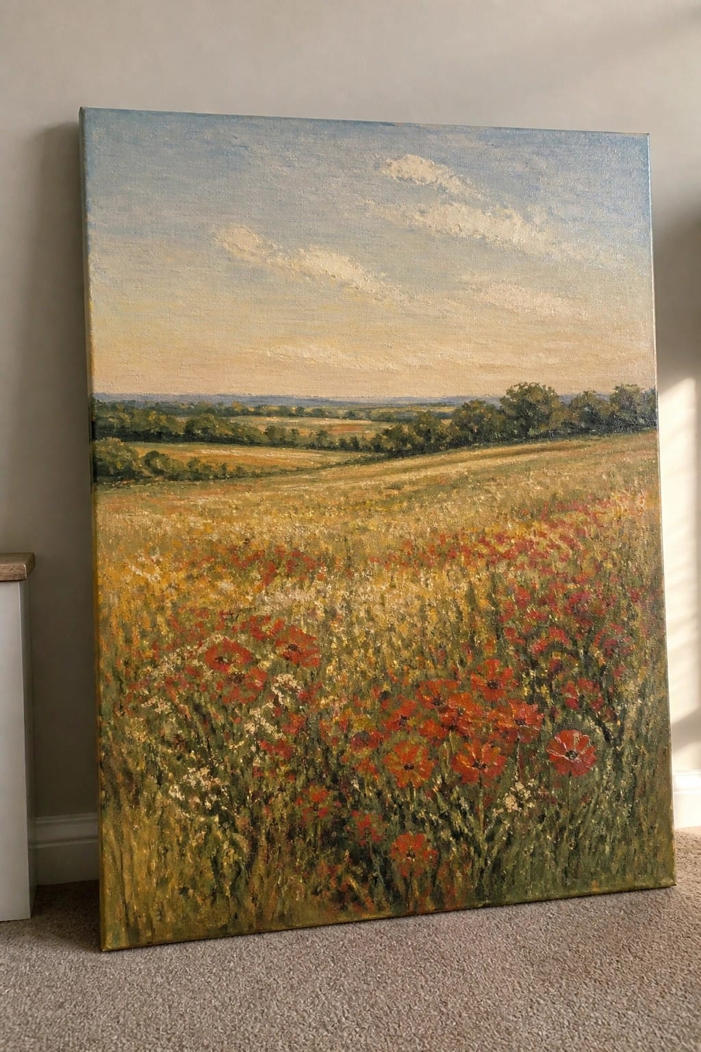 Large oil painting of vibrant red poppy field under cloudy blue sky