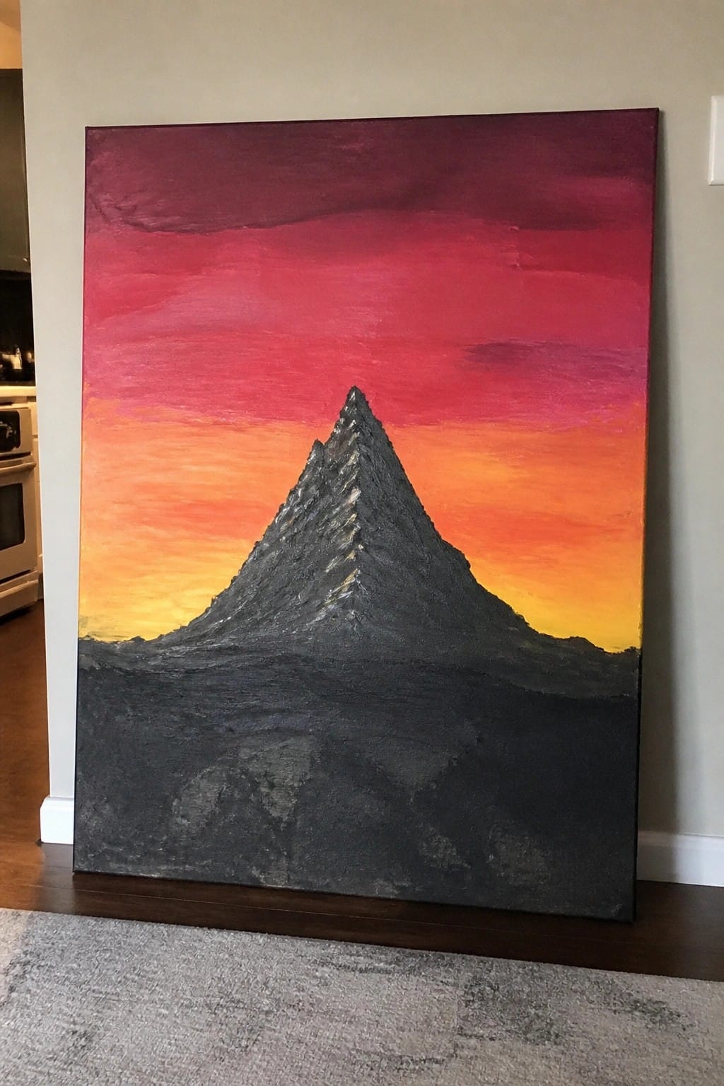 Textured painting of jagged dark mountain peak against vibrant red-orange sunset sky.