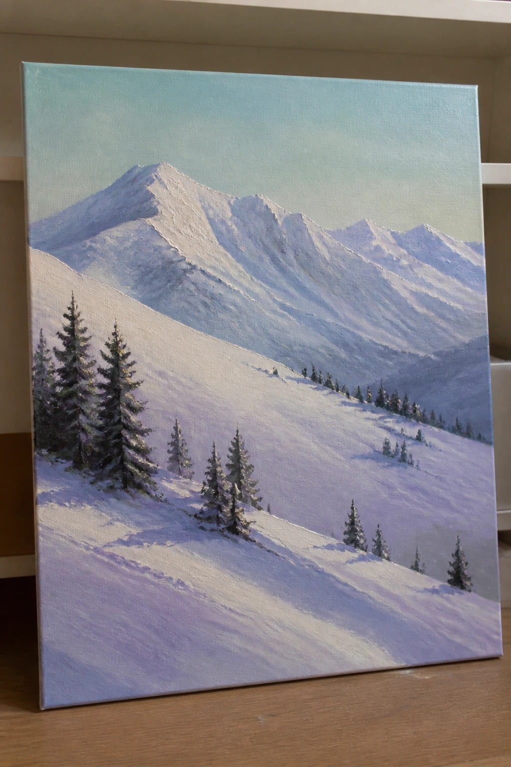 Oil painting of snow-covered mountains with pine trees on canvas slopes