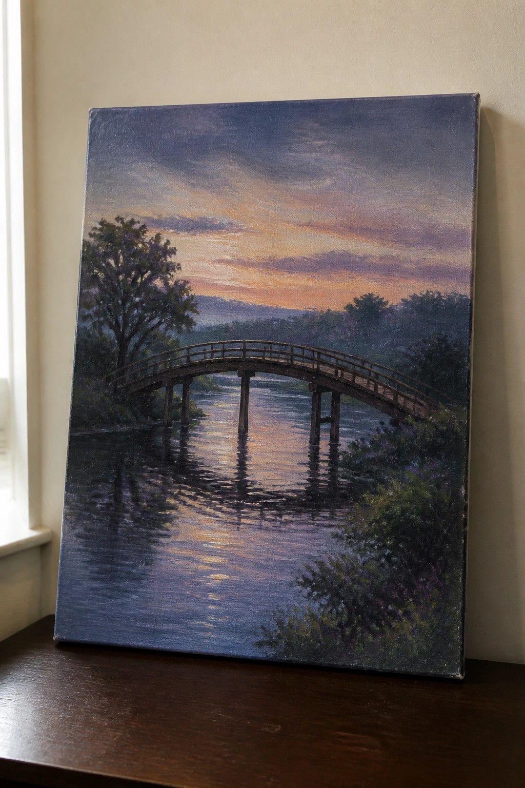 Oil painting of arched wooden bridge over river reflecting vibrant sunset colors