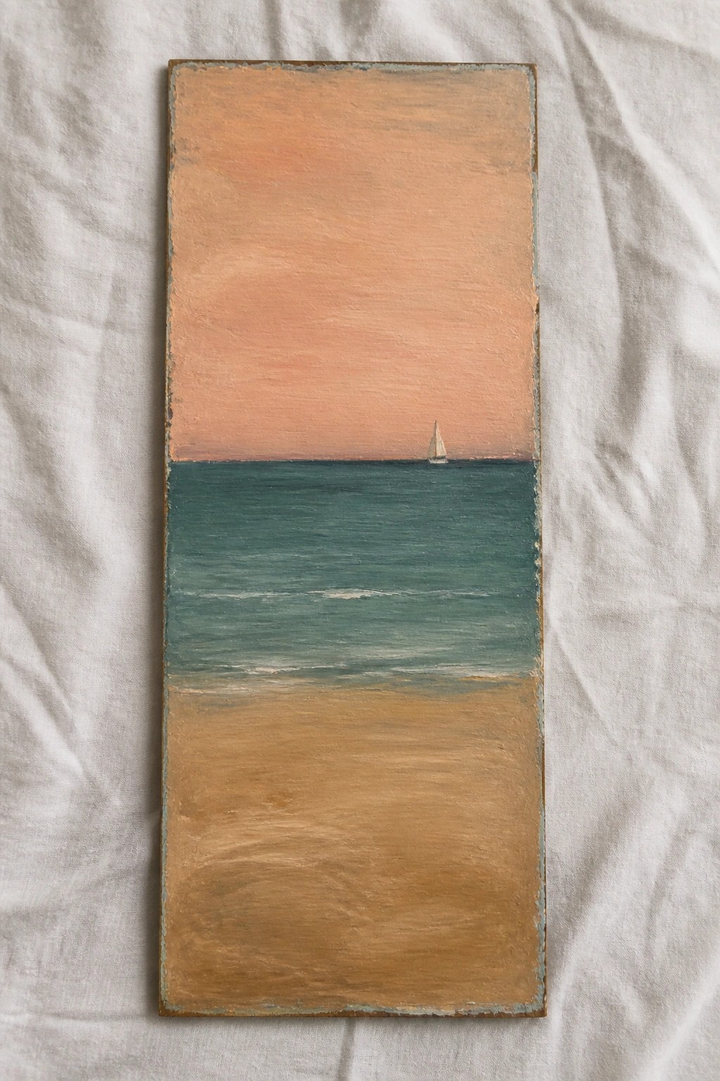 Tall rectangular painting of beach, teal sea, distant sailboat, and orange-pink sunset sky.