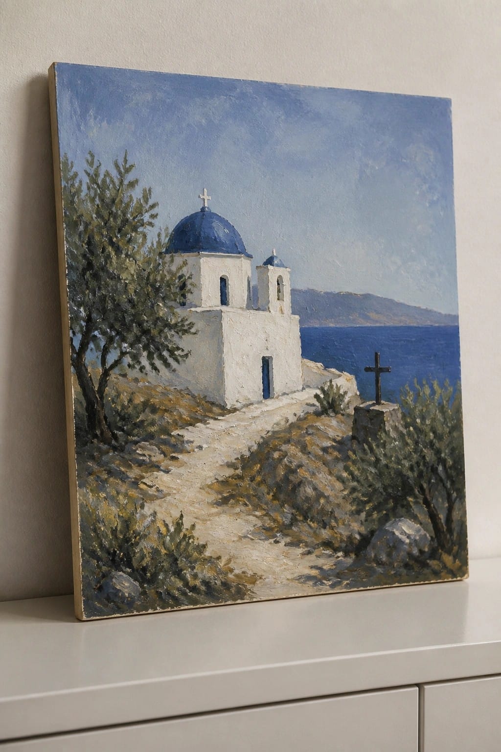 Oil painting of white Greek church with blue dome by the sea on a cliff