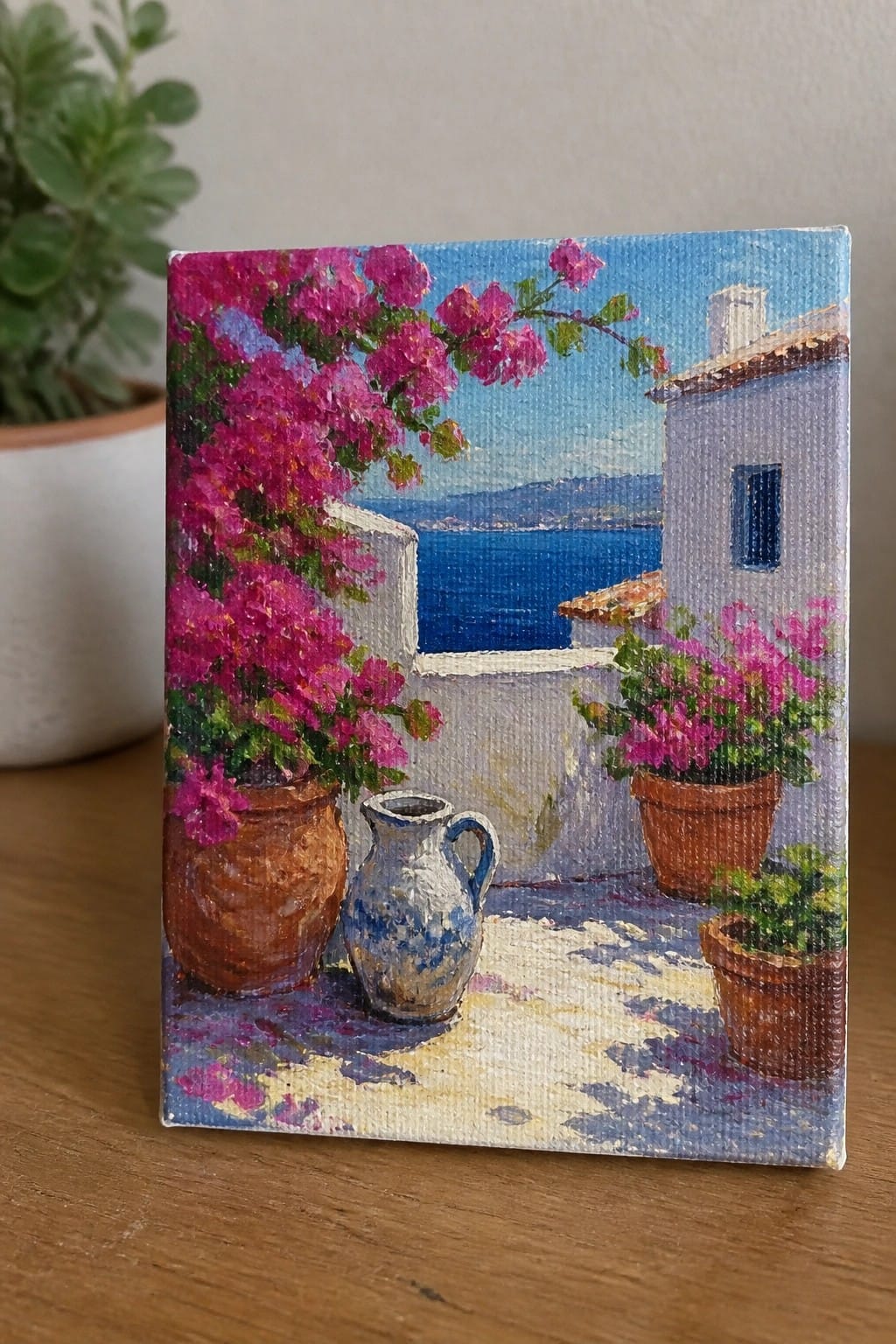 Colorful painting of pink bougainvillea on sunny seaside terrace with white buildings and jug