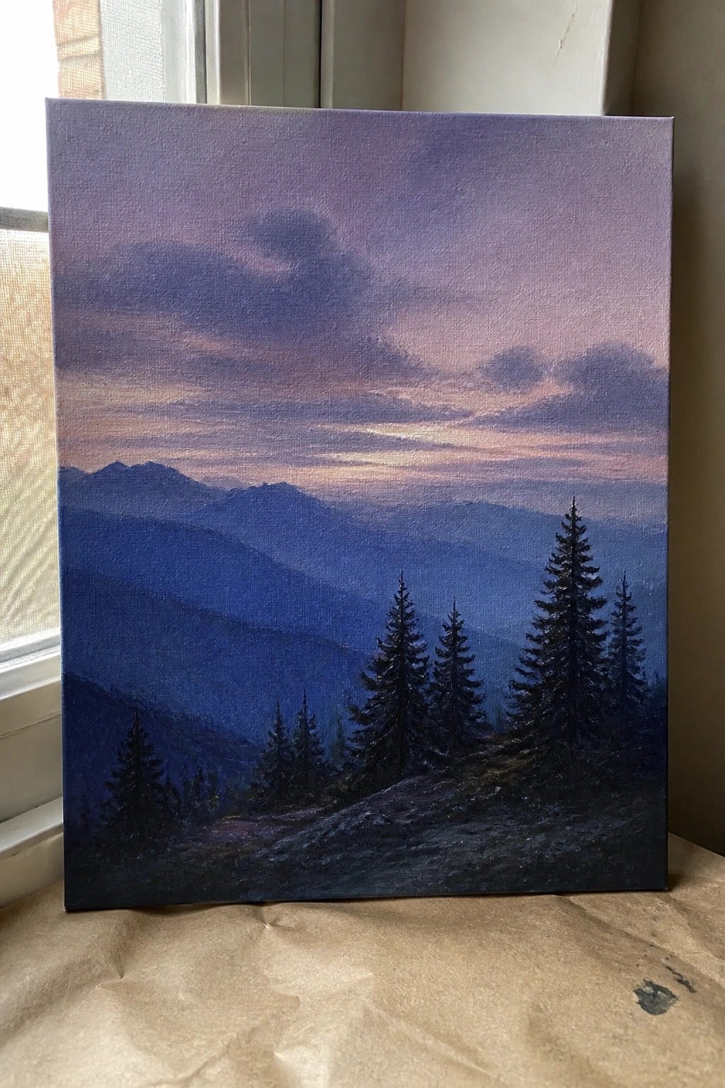 Landscape painting of misty blue mountains at dusk with silhouetted pine trees