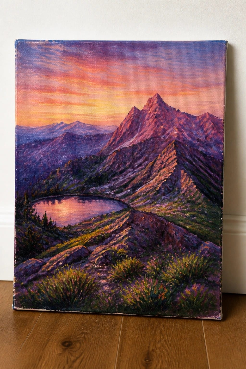 Vibrant sunset painting of purple mountains with reflective lake on canvas.