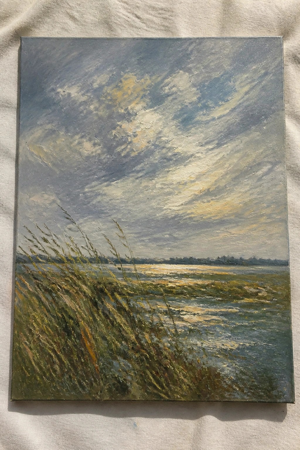 Impressionist oil painting of windswept grass by shimmering water under dramatic cloudy sky
