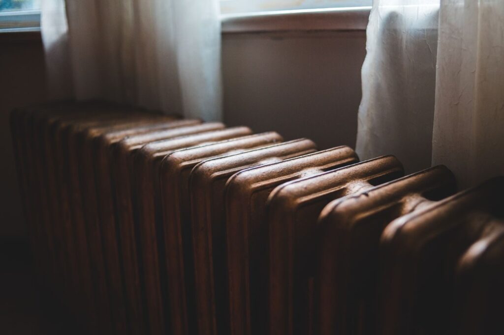 Indoor cast-iron residential radiator under a window